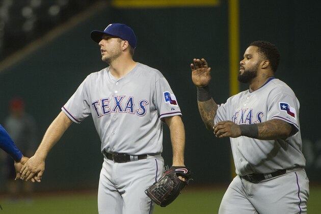 Texas Rangers' Shawn Tolleson, left, and Prince Fielder react after the Rangers defeated the Cleveland Indians in a baseball game in Cleveland, Tuesday, May 26, 2015. The Rangers won 4-3. (AP Photo/Phil Long)