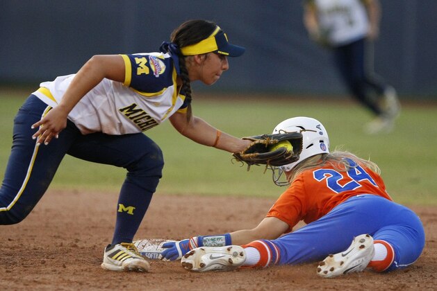 Florida's Kirsti Merritt (24) makes it to second base ahead of the tab by Michigan infielder Sierra Romero during the sixth inning of Game 2 of the finals in the NCAA softball Women's College World Series, Tuesday, June 2, 2015, in Oklahoma City. Michigan won 1-0. (AP Photo/Alonzo Adams)