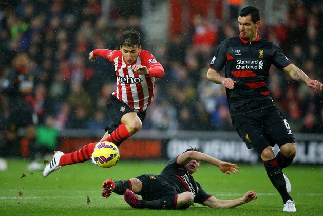 SOUTHAMPTON, ENGLAND - FEBRUARY 22: Filip Djuricic of Southampton is tackled by Joe Allen of Liverpool during the Barclays Premier League match between Southampton and Liverpool at St Mary's Stadium on February 22, 2015 in Southampton, England.  (Photo by Richard Heathcote/Getty Images)