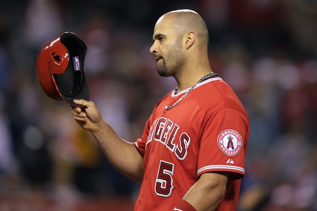 Los Angeles Angels' Albert Pujols takes off his helmet after he flied out during the eighth inning of a baseball game against the Tampa Bay Rays, Tuesday, June 2, 2015, in Anaheim, Calif. (AP Photo/Jae C. Hong)