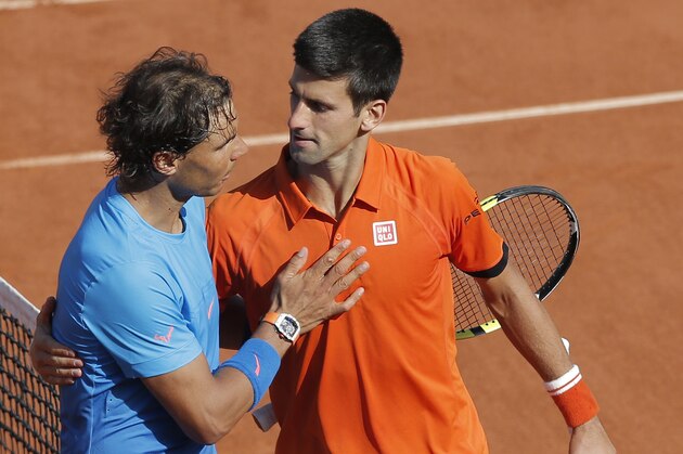 Serbia's Novak Djokovic hugs Spain's Rafael Nadal, left, after winning the quarterfinal match of the French Open tennis tournament in three sets, 7-5, 6-3, 6-1, at the Roland Garros stadium, in Paris, France, Wednesday, June 3, 2015. (AP Photo/Christophe Ena)