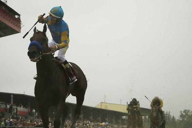 American Pharoah, ridden by Victor Espinoza  wins the 140th Preakness Stakes horse race at Pimlico Race Course, Saturday, May 16, 2015, in Baltimore. (AP Photo/Matt Slocum)