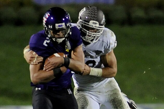 Northwestern's Kain Colter (2) gets taken down by Western Michigan's Justin Currie (33) during an NCAA college football game in Evanston, Ill.,  Saturday, Sept. 14, 2013. (AP Photo/Matt Marton)
