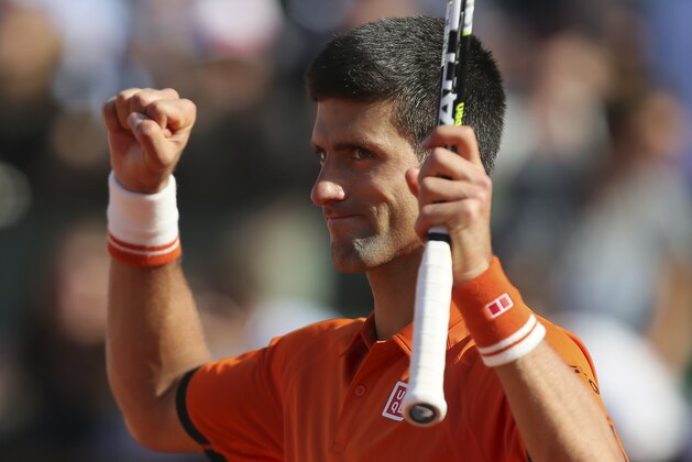 Serbia's Novak Djokovic celebrates winning the quarterfinal match of the French Open tennis tournament against Spain's Rafael Nadal in three sets, 7-5, 6-3, 6-1, at the Roland Garros stadium, in Paris, France, Wednesday, June 3, 2015. (AP Photo/David Vincent)