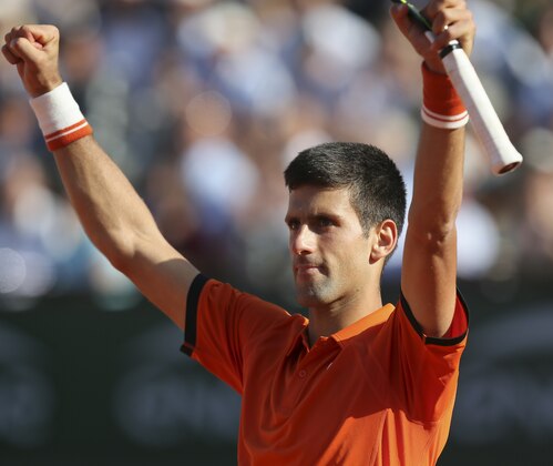 Serbia's Novak Djokovic celebrates winning the quarterfinal match of the French Open tennis tournament against Spain's Rafael Nadal in three sets, 7-5, 6-3, 6-1, at the Roland Garros stadium, in Paris, France, Wednesday, June 3, 2015. (AP Photo/David Vincent)