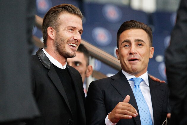 PARIS, FRANCE - SEPTEMBER 30:  David Beckham and Fabio Cannavaro share a joke prior to the Group F UEFA Champions League match between Paris Saint-Germain v FC Barcelona held at Parc des Princes on September 30, 2014 in Paris, France.  (Photo by Dean Mouhtaropoulos/Getty Images)