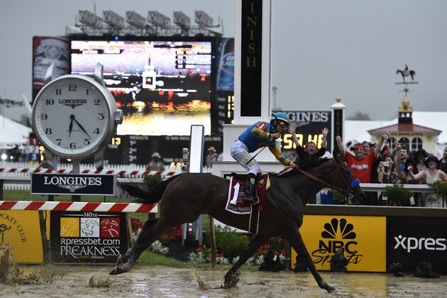 American Pharoah, ridden by Victor Espinoza, wins the 140th Preakness Stakes horse race at Pimlico Race Course, Saturday, May 16, 2015, in Baltimore. (AP Photo/Mike Stewart)