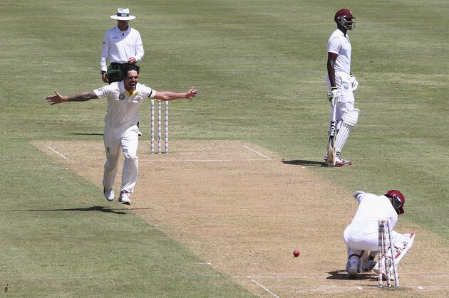 ROSEAU, DOMINICA - JUNE 03:  Mitchell Johnson of Australia celebrates after bowling Denesh Ramdin of West Indies during day one of the First Test match between Australia and the West Indies at Windsor Park on June 3, 2015 in Roseau, Dominica.  (Photo by Ryan Pierse/Getty Images)