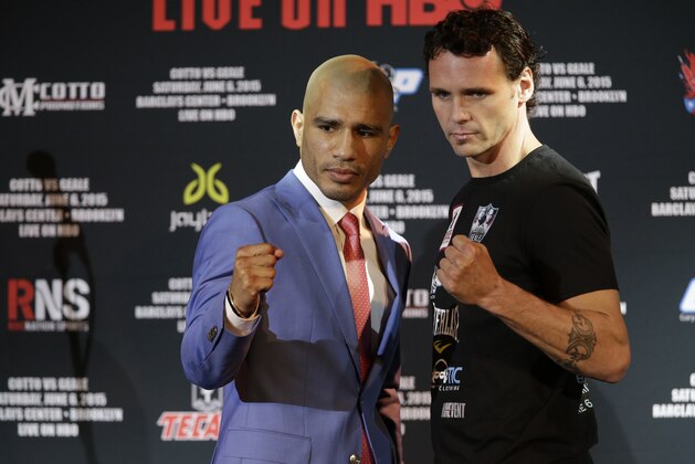 Boxers Miguel Cotto, left, and Daniel Geale pose for photographers during a news conference, Tuesday, June 2, 2015, in New York. Cotto is slated to defend his WBC world middleweight title against Geale on Saturday, June 6, at Barclays Center in the Brooklyn borough of New York.  (AP Photo/Mary Altaffer)