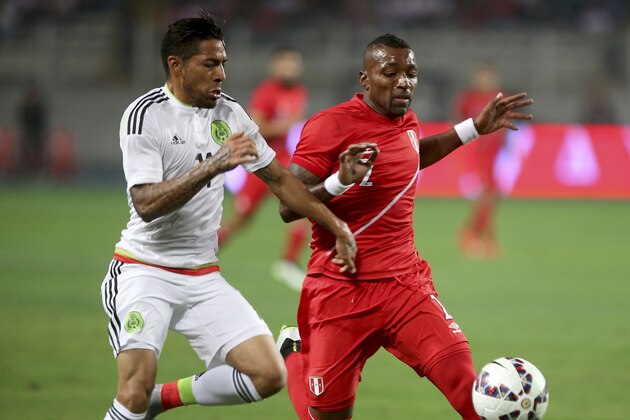 Mexico's Javier Aquino, left, fights for the ball with Peru's Jair Cespedes during a friendly soccer match ahead of the Copa America 2015 soccer tournament in Lima, Peru, Wednesday, June 3, 2015. (AP Photo/ Raul Sifuentes)
