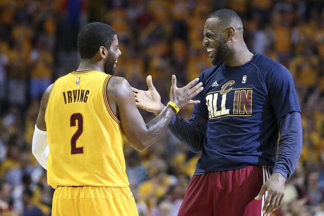 Cleveland Cavaliers forward LeBron James (23) and Cleveland Cavaliers guard Kyrie Irving (2) slap hands during a timeout in the first quarter of Game 4 of the NBA basketball Eastern Conference Finals against the Atlanta Hawks, Tuesday, May 26, 2015, in Cleveland. (AP Photo/Ron Schwane)