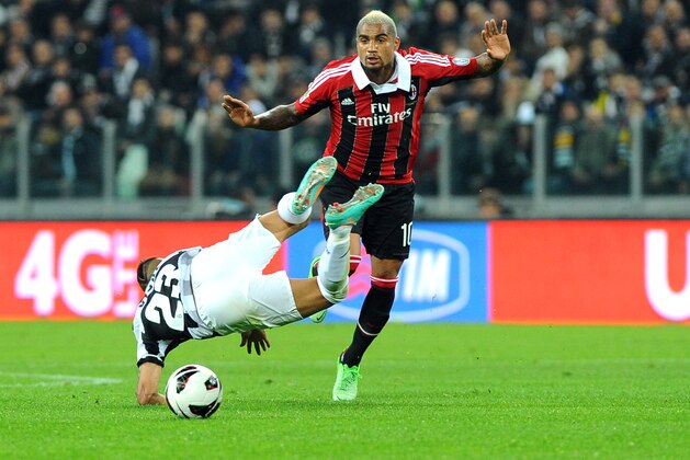 AC Milan's Kevin Prince Boateng, of Ghana, right, vies for the ball with Juventus' Arturo Vidal, of Chile, during a Serie A soccer match at the Juventus Stadium in Turin, Italy, Sunday, April 21, 2013. (AP Photo/Massimo Pinca)
