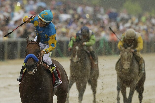 American Pharoah, ridden by Victor Espinoza, left, wins the 140th Preakness Stakes horse race at Pimlico Race Course, Saturday, May 16, 2015, in Baltimore. (AP Photo/Matt Slocum)