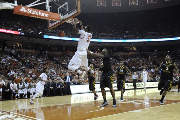 Jan 17, 2015; Austin, TX, USA; Texas Longhorns forward Myles Turner (52) dunks over West Virginia Mountaineers forward Elijah Macon (45) during the second half at the Frank Erwin Special Events Center. Texas beat West Virginia 77-50. Mandatory Credit: Brendan Maloney-USA TODAY Sports