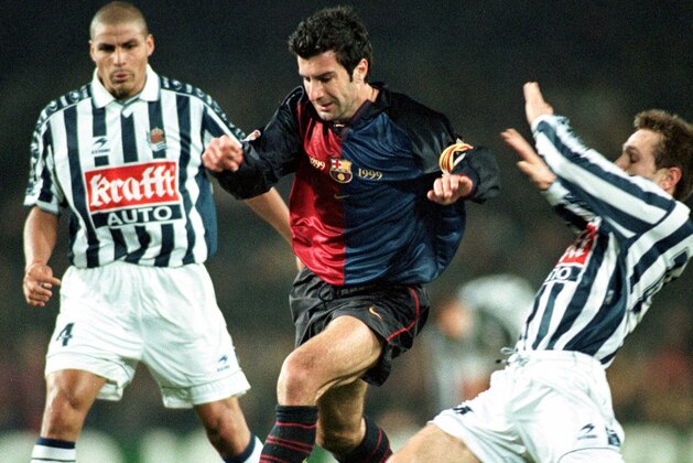 Barcelona's Portuguese Luis Figo, center, battles for the ball with Real Sociedad's Andres Gomez, left, and Aitor Lopez Rekarte  during a league soccer match in Barcelona Wednesday January 5, 2000. Barcelona won the game 3-1. (AP Photo/Cesar Rangel)