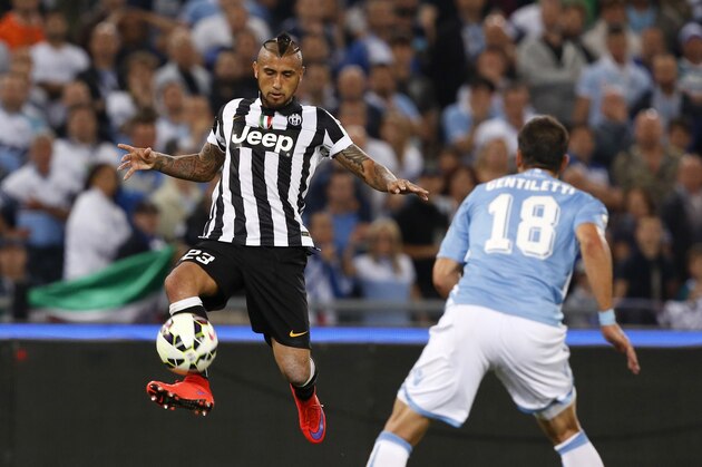 Juventus’ Arturo Vidal, left, kicks the ball past Lazio’s Santiago Gentiletti during the Italian Cup final soccer match between Juventus and Lazio, at Rome's Olympic stadium, Wednesday, May 20, 2015. (AP Photo/Riccardo De Luca)