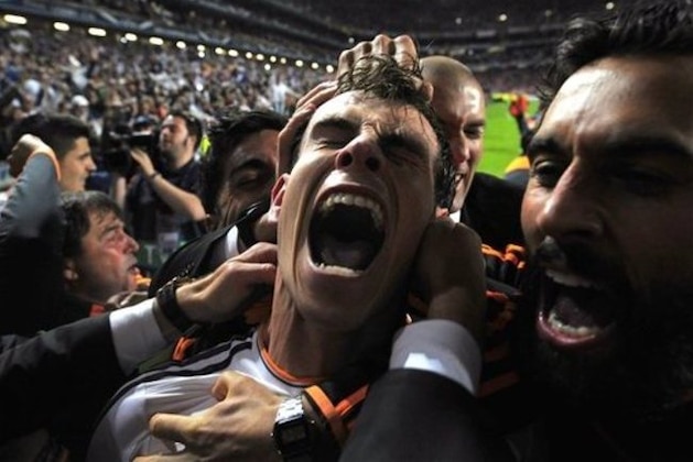 FILE - In this Saturday, May 24, 2014 file photo, Real Madrid's Gareth Bale celebrates with teammates after scoring his side's second goal in the Champions League final soccer match against Atletico Madrid at the Luz Stadium in Lisbon, Portugal. Real Madrid became the first team to win the European Cup 10 times, dubbed “La Decima.” The 4-1 scoreline did not do justice to Atletico, which was just 90 seconds away from securing its first European Cup before Sergio Ramos headed Real Madrid level. Extra time saw Real Madrid run away from its city rival, with goals from Bale, Marcelo and Ronaldo. (AP Photo/Manu Fernandez, File)
