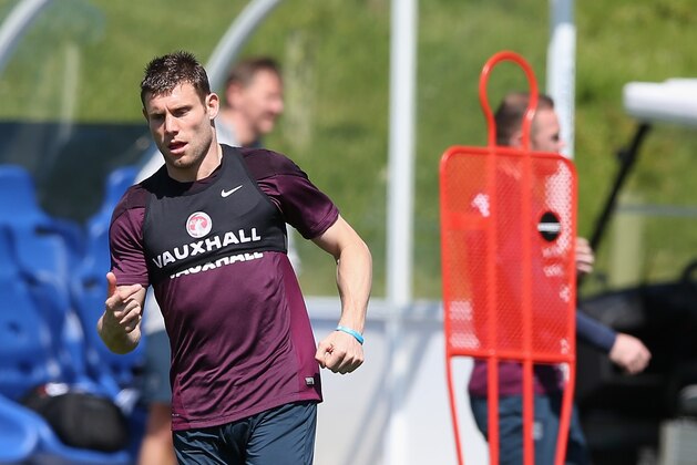 BURTON-UPON-TRENT, ENGLAND - JUNE 04: James Milner passes the ball during the England training session held at St Georges Park on June 4, 2015 in Burton-upon-Trent, England.  (Photo by David Rogers/Getty Images)