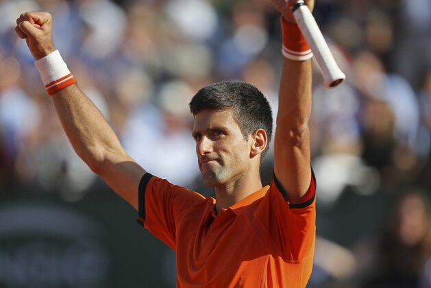 Serbia's Novak Djokovic celebrates winning the quarterfinal match of the French Open tennis tournament against Spain's Rafael Nadal in three sets, 7-5, 6-3, 6-1, at the Roland Garros stadium, in Paris, France, Wednesday, June 3, 2015. (AP Photo/David Vincent)
