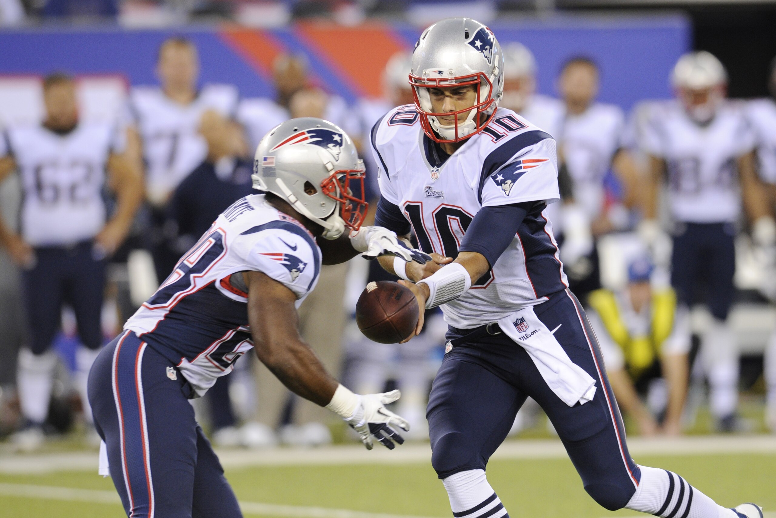 New England Patriots quarterback Jimmy Garoppolo, right, hands off to James White during the first half of an NFL football game between the New England Patriots and the New York Giants, Thursday, Aug. 28, 2014, in East Rutherford, N.J. (AP Photo/Bill Kostroun)