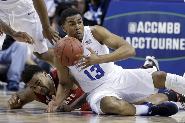 Duke's Matt Jones, front, and North Carolina State's Trevor Lacey, back, scramble for a loose ball during the first half of an NCAA college basketball game in the quarterfinals of the Atlantic Coast Conference tournament in Greensboro, N.C., Thursday, March 12, 2015. (AP Photo/Bob Leverone)