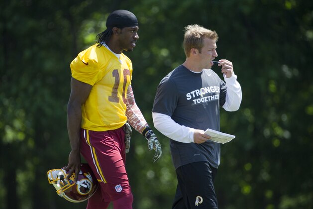 Washington Redskins offensive coordinator Sean McVay, right, walks with quarterback Robert Griffin III during an NFL football organized team activity at Redskins Park, on Tuesday, May 26, 2015, in Ashburn, Va. (AP Photo/Evan Vucci)
