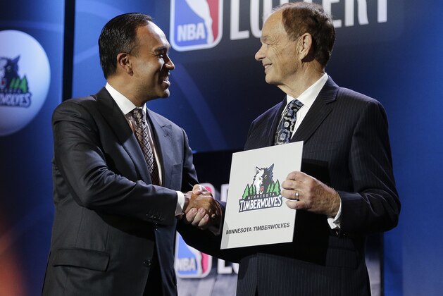 NBA Deputy Commissioner Mark Tatum, left, congratulates Minnesota Timberwolves owner Glen Taylor after the Timberwolves won the first pick in the draft, during the NBA basekball draft lottery, Tuesday, May 19, 2015, in New York. (AP Photo/Julie Jacobson)