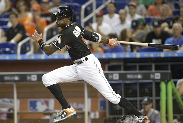 Miami Marlins' Dee Gordon bats in the fifth inning of a baseball game against the Atlanta Braves, Saturday, May 16, 2015, in Miami. Gordon grounded out to the shortstop on the play. The Braves defeated the Marlins 5-3. (AP Photo/Lynne Sladky)