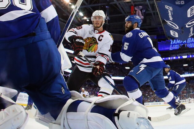 TAMPA, FL - JUNE 03: Jonathan Toews #19 of the Chicago Blackhawks skates against Ben Bishop #30 and Jason Garrison #5 of the Tampa Bay Lightning  during Game One of the 2015 NHL Stanley Cup Final at Amalie Arena on June 3, 2015 in Tampa, Florida. The Blackhawks defeated the Lightning 2-1.  (Photo by Bruce Bennett/Getty Images)