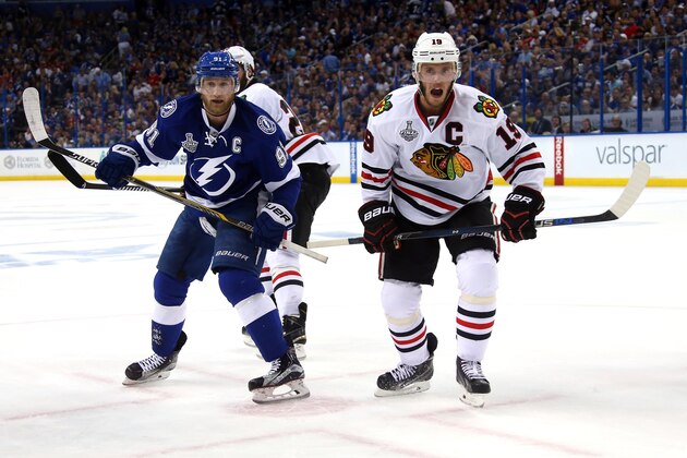 TAMPA, FL - JUNE 03: Steven Stamkos #91 of the Tampa Bay Lightning and Jonathan Toews #19 of the Chicago Blackhawks go for a loose puck during Game One of the 2015 NHL Stanley Cup Final at Amalie Arena on June 3, 2015 in Tampa, Florida.  (Photo by Bruce Bennett/Getty Images)