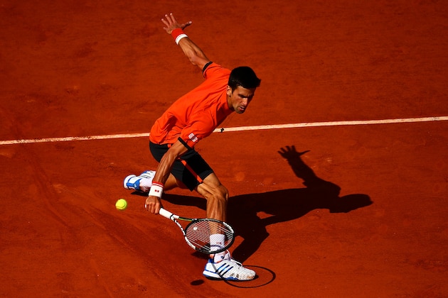 PARIS, FRANCE - JUNE 03:  Novak Djokovic of Serbia returns a shot in his Men's quarter final match against Rafael Nadal of Spain on day eleven of the 2015 French Open at Roland Garros on June 3, 2015 in Paris, France.  (Photo by Dan Istitene/Getty Images)