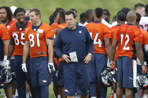 Denver Broncos head coach Gary Kubiak heads to the lockerroom after taking part in a team huddle at the conclusion of an organized training activity at the NFL football team's headquarters in Englewood, Colo., Monday, June 1, 2015. (AP Photo/David Zalubowski)