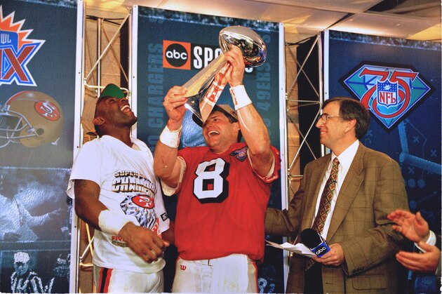 San Francisco quarterback Steve Young, center, and receiver Jerry Rice, left, celebrate with the Lombardi Trophy after their 49-26 victory over the San Diego Chargers in Super Bowl XXIX at Joe Robbie Stadium in Miami, Fla., Sunday, Jan. 29, 1995.  Young, who threw a Super Bowl record six touchdown passes, was voted the most valuable player of the game.  The 49ers won 49-26.  Man at right is unidentified.  (AP Photo/Eric Risberg)