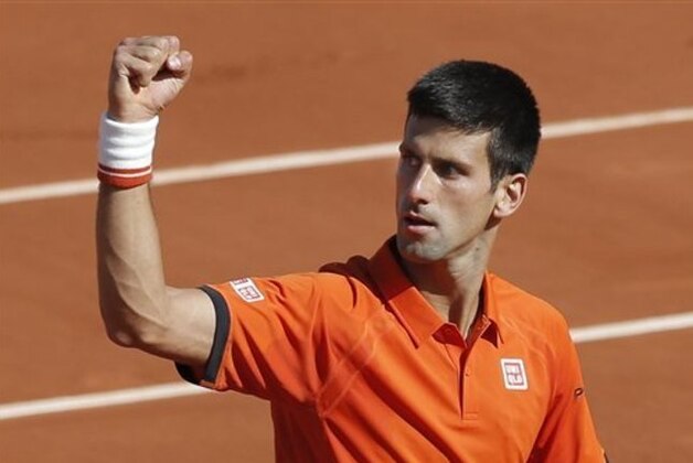 Serbia's Novak Djokovic clenches his fist after scoring a point in the quarterfinal match of the French Open tennis tournament against Spain's Rafael Nadal at the Roland Garros stadium, in Paris, France, Wednesday, June 3, 2015. (AP Photo/Christophe Ena)