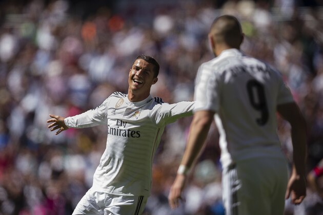 Real Madrid's Cristiano Ronaldo celebrates with team mate Karim Benzema, right, after scoring a goal during a La Liga soccer match between Real Madrid and Granada at the Santiago Bernabeu stadium in Madrid, Spain, Sunday, April 5, 2015. (AP Photo/Daniel Ochoa de Olza)