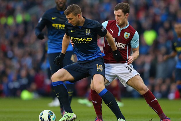 BURNLEY, ENGLAND - MARCH 14:  Edin Dzeko of Manchester City holds off Ashley Barnes of Burnley during the Barclays Premier League match between Burnley and Manchester City at Turf Moor on March 14, 2015 in Burnley, England.  (Photo by Alex Livesey/Getty Images)