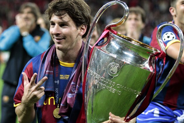 Barcelona's Lionel Messi celebrates with the trophy after winning the Champions League final soccer match against Manchester United at Wembley Stadium, London, Saturday, May 28, 2011. (AP Photo/Jon Super)