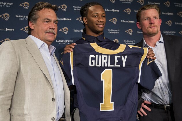 St. Louis Rams head coach Jeff Fisher, left, and general manager Les Snead, right, introduce first-round draft pick Todd Gurley during a news conference at the NFL football team's practice facility Friday, May 1, 2015, in St. Louis. Gurley, a running back from Georgia, was picked tenth overall by the Rams. (AP Photo/Whitney Curtis)