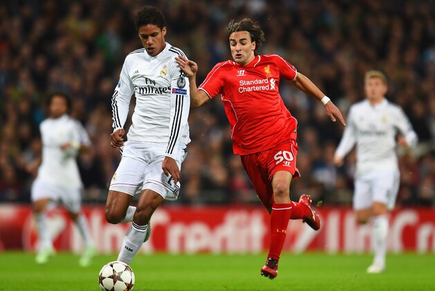 MADRID, SPAIN - NOVEMBER 04: Raphael Varane of Real Madrid CF and Lazar Markovic of Liverpool compete for the ball during the UEFA Champions League Group B match between Real Madrid CF and Liverpool FC at Estadio Santiago Bernabeu on November 4, 2014 in Madrid, Spain.  (Photo by Shaun Botterill/Getty Images)