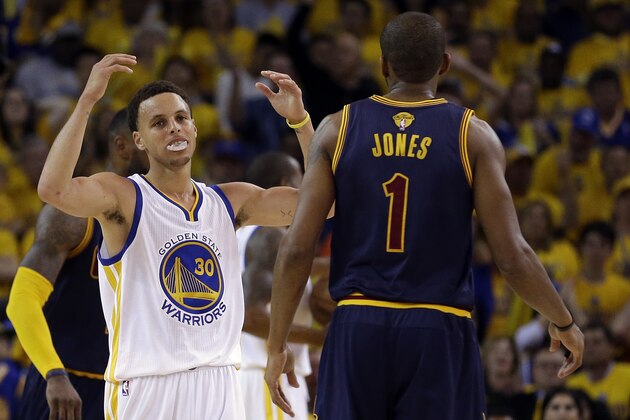 Golden State Warriors guard Stephen Curry (30) reacts next to Cleveland Cavaliers forward James Jones (1) during the second half of Game 1 of basketball's NBA Finals in Oakland, Calif., Thursday, June 4, 2015. (AP Photo/Ben Margot)