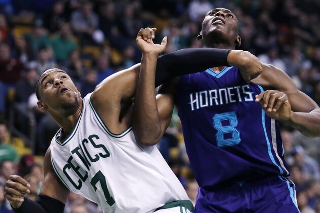 Boston Celtics forward Jared Sullinger (7) and Charlotte Hornets center Bismack Biyombo (8) battle for a rebound during the second half of an NBA basketball game in Boston, Monday, Jan. 5, 2015. The Hornets defeated the Celtics 104-95. (AP Photo/Charles Krupa)