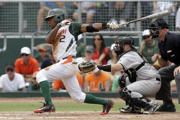 Miami's Ricky Eusebio (2) follows through on a base hit driving in Jacob Heyward against VCU during the second inning in the super regionals of the NCAA college baseball tournament, Friday, June 5, 2015, in Coral Gables, Fla. (AP Photo/Alan Diaz)