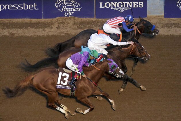 Jockey Martin Garcia, right, rides Bayern to victory in the Breeders' Cup Classic horse race past Jockey Victor Espinoza on California Chrome, left, and Jockey Jamie Spencer on Toast of New York at Santa Anita Park, Saturday, Nov. 1, 2014, in Arcadia, Calif. (AP Photo/Jae C. Hong)