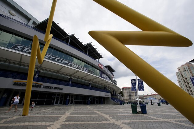 Fans gather outside Amalie Arena, home of the Tampa Bay Lightning,  Friday, June 5, 2015, in Tampa, Fla. While Sun Belt NHL teams from Phoenix to Miami struggle to maintain revenue and relevance in their communities, the Tampa Bay Lightning are thriving. The franchise’s second trip to the Stanley Cup Final is the highlight of a revival under owner Jeff Vinik as the organization builds a vibrant hockey town in a warm-weather climate. Game 2 is scheduled for Saturday night against the Chicago Blackhawks. (AP Photo/Chris Carlson)