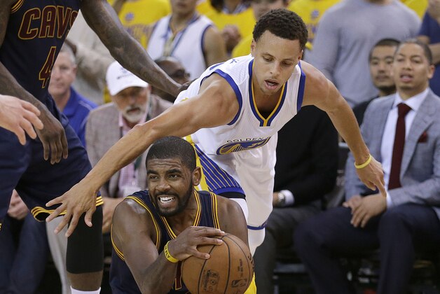 Cleveland Cavaliers guard Kyrie Irving, bottom, is guarded by Golden State Warriors guard Stephen Curry during the second half of Game 1 of basketball's NBA Finals in Oakland, Calif., Thursday, June 4, 2015. (AP Photo/Ben Margot)