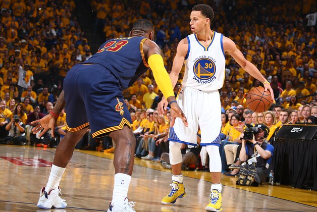 OAKLAND, CA - JUNE 4: Stephen Curry #30 of the Golden State Warriors is guarded by LeBron James #23 of the Cleveland Cavaliers during Game One of the 2015 NBA Finals on June 4, 2015 at Oracle Arena in Oakland, California. NOTE TO USER: User expressly acknowledges and agrees that, by downloading and or using this photograph, user is consenting to the terms and conditions of Getty Images License Agreement. Mandatory Copyright Notice: Copyright 2015 NBAE (Photo by Nathaniel S. Butler/NBAE via Getty Images)