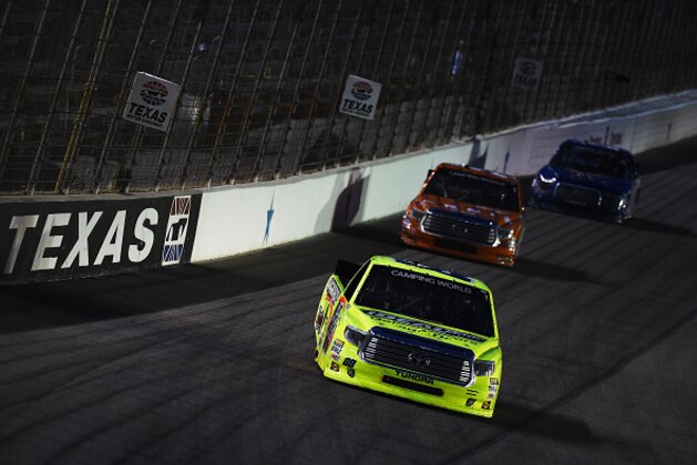 FORT WORTH, TX - JUNE 05:  Matt Crafton, driver of the #88 Ideal Door/Menards Toyota, leads a pack of cars during the NASCAR Camping World Truck Series WinStar World Casino & Resort 400 at Texas Motor Speedway on June 5, 2015 in Fort Worth, Texas.  (Photo by Rainier Ehrhardt/Getty Images for Texas Motor Speedway)
