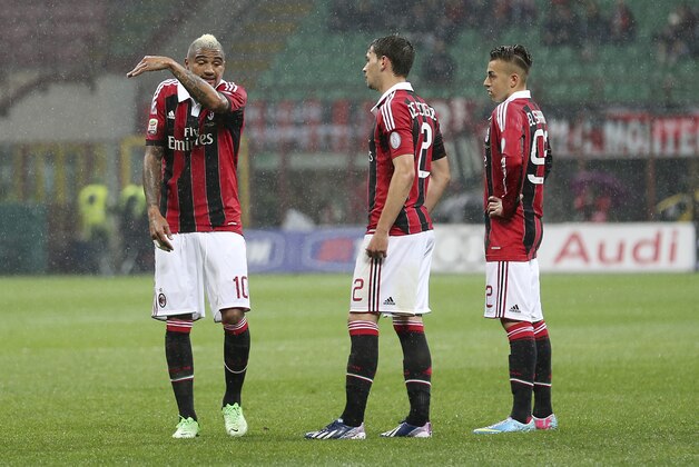 AC Milan midfielder Kevin Prince Boateng, left, of Ghana, talks with his teammates forward Stephan El Shaarawy, right, and defender Mattia De Sciglio during the Serie A soccer match between AC Milan and Catania at the San Siro stadium in Milan, Italy, Sunday, April 28, 2013. (AP Photo/Antonio Calanni)