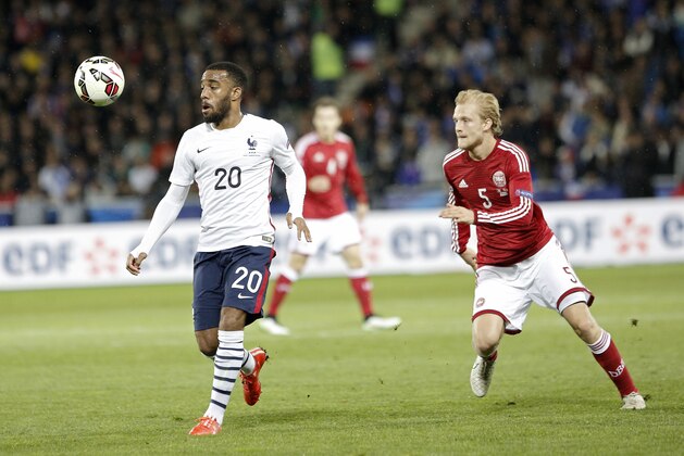 France’s Alexandre Lacazette, left, challenges for the ball with Denmark's Nicolai Boilesen during their international friendly soccer match at Geoffroy Guichard stadium in Saint-Etienne, central France, Sunday, March 29, 2015. (AP Photo/Laurent Cipriani)