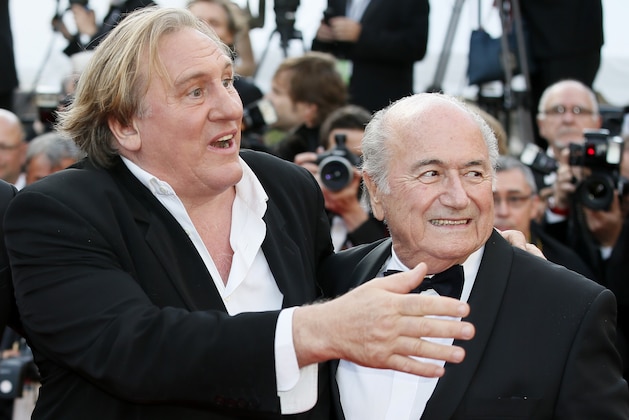 FILE - This is a Sunday, May 18, 2014 file photo of  FIFA President Sepp Blatter, right, and actor Gerard Depardieu as they pose for photographers as they arrive for the screening of The Homesman at the 67th international film festival, Cannes, southern France. Funded with $27 million of FIFA money, the movie “United Passions” is acquiring almost mythical status in football circles. Mythical in the sense that the film, which was shown at the Zurich Film Festival on Sunday, has not been seen by many, and its relationship to documentary truth about FIFA’s troubled recent history is loose. In industry circles, “United Passions” would easily be defined as a box office flop _ even with star power from Gerard Depardieu, Sam Neill and Tim Roth. (AP Photo/Alastair Grant, File)